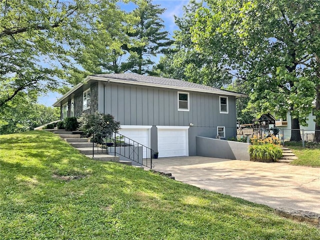 118 Fern St, Lansing, KS 66043 - view of property exterior featuring driveway, a garage, and stairway