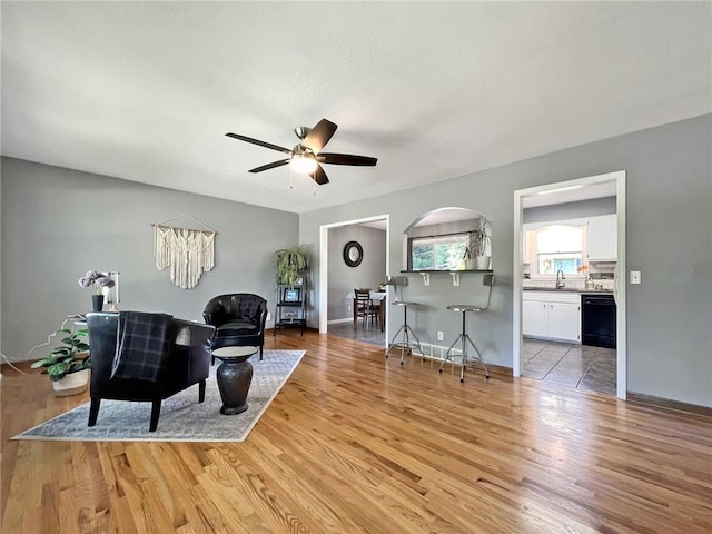 118 Fern St, Lansing, KS 66043 - living room featuring light wood-style floors, ceiling fan, and arched walkways