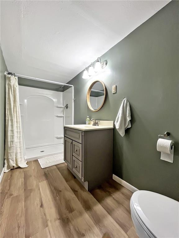 118 Fern St, Lansing, KS 66043 - full bathroom featuring a shower with shower curtain, vanity, and wood finished floors