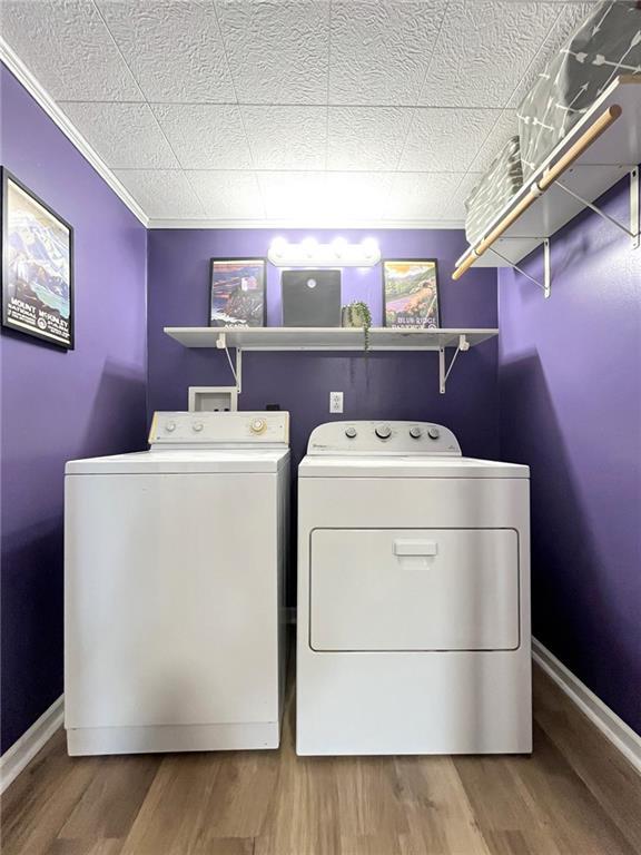118 Fern St, Lansing, KS 66043 - washroom with separate washer and dryer, ornamental molding, and wood finished floors