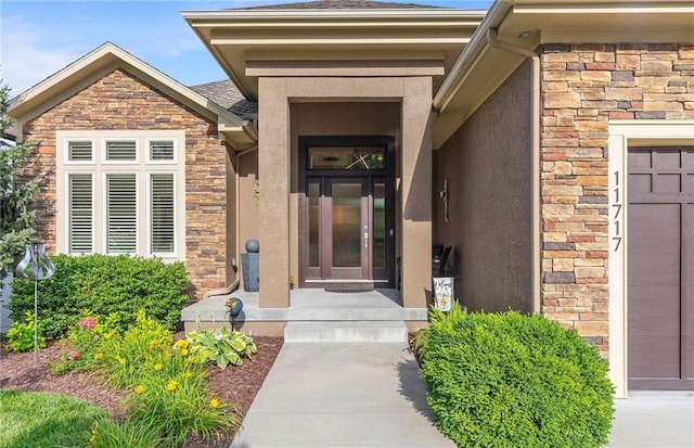 11717 S Barth Rd, Olathe, KS 66061 - property entrance with a garage, stucco siding, and stone siding