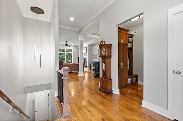 11717 S Barth Rd, Olathe, KS 66061 - hallway featuring decorative columns, light wood finished floors, crown molding, and recessed lighting