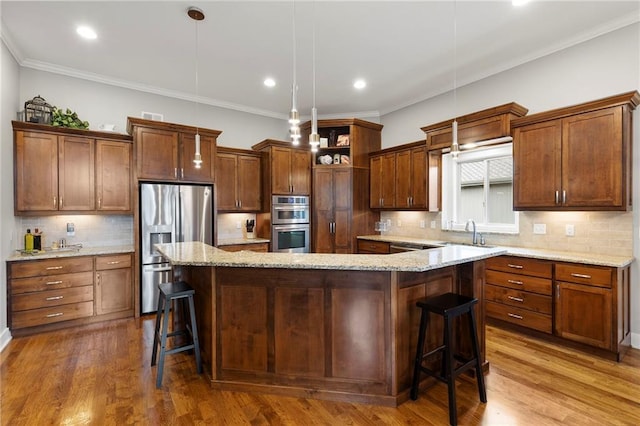 11717 S Barth Rd, Olathe, KS 66061 - kitchen with stainless steel appliances, a kitchen bar, backsplash, a spacious island, and crown molding