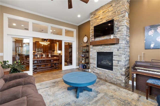 11717 S Barth Rd, Olathe, KS 66061 - living room with crown molding, a ceiling fan, a fireplace, and recessed lighting