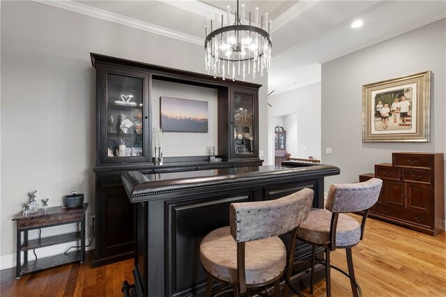 11717 S Barth Rd, Olathe, KS 66061 - bar with wood finished floors, a chandelier, crown molding, and recessed lighting
