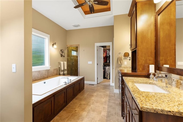 11717 S Barth Rd, Olathe, KS 66061 - full bathroom featuring vanity, a garden tub, ceiling fan, a spacious closet, and tiled shower
