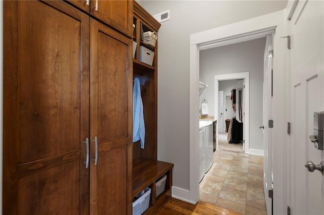 11717 S Barth Rd, Olathe, KS 66061 - mudroom with baseboards and washer and dryer