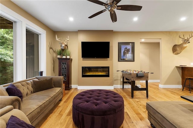 11717 S Barth Rd, Olathe, KS 66061 - living area featuring recessed lighting, a glass covered fireplace, ceiling fan, and light wood-style floors
