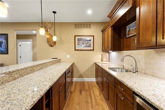 11717 S Barth Rd, Olathe, KS 66061 - kitchen featuring light wood-type flooring, tasteful backsplash, light stone countertops, decorative light fixtures, and recessed lighting