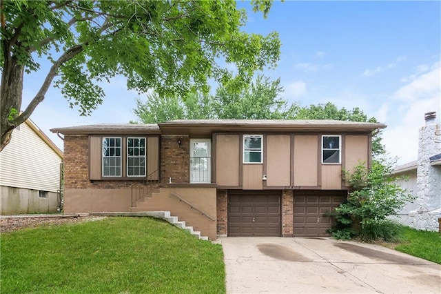 20408 E 15th Ter, Independence, MO 64056 - view of front facade with brick siding, an attached garage, a front yard, concrete driveway, and stairway