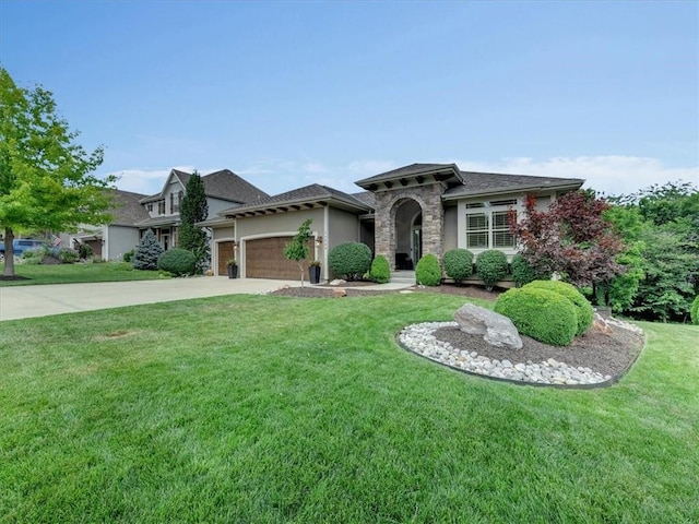 11599 S Carbondale St, Olathe, KS 66061 - view of front of house featuring a garage, a front yard, concrete driveway, stone siding, and stucco siding