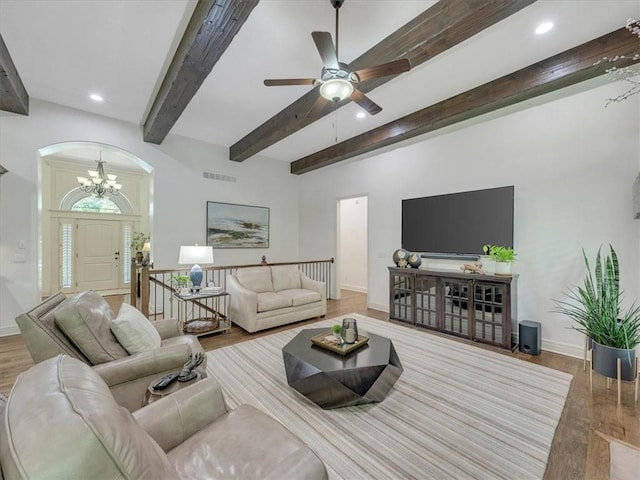 11599 S Carbondale St, Olathe, KS 66061 - living area with beam ceiling, wood finished floors, arched walkways, a chandelier, and ceiling fan