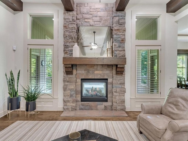 11599 S Carbondale St, Olathe, KS 66061 - living room featuring beam ceiling, ceiling fan, and a fireplace
