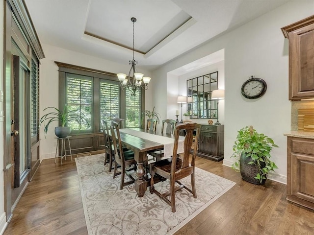 11599 S Carbondale St, Olathe, KS 66061 - dining area with a chandelier, dark wood finished floors, and a raised ceiling