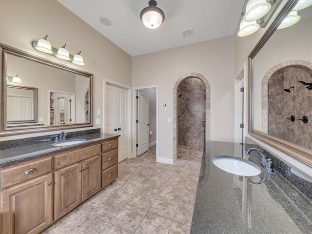 11599 S Carbondale St, Olathe, KS 66061 - full bathroom featuring a tile shower, tile patterned flooring, and two vanities