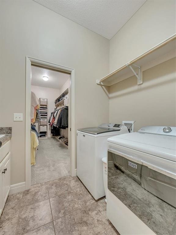 11599 S Carbondale St, Olathe, KS 66061 - laundry area with separate washer and dryer, cabinet space, and a textured ceiling