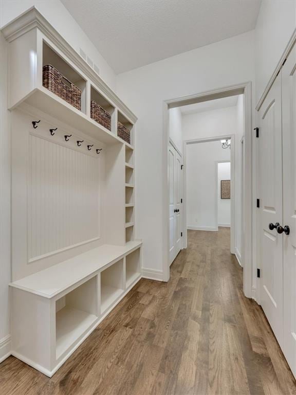 11599 S Carbondale St, Olathe, KS 66061 - mudroom featuring wood finished floors and baseboards