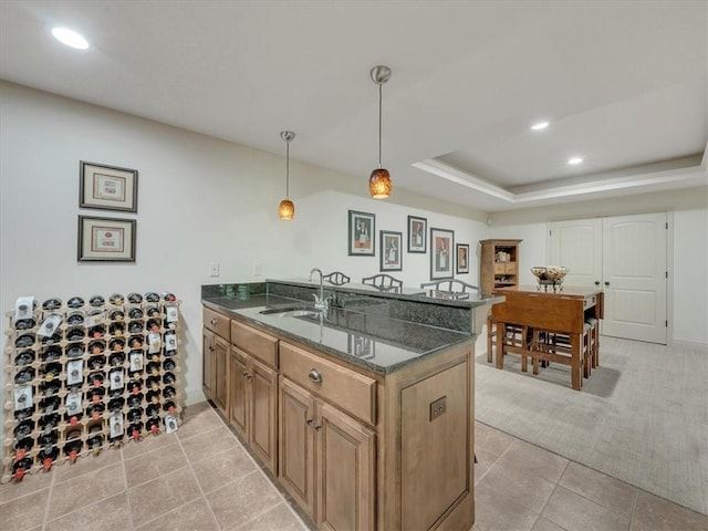 11599 S Carbondale St, Olathe, KS 66061 - kitchen with a peninsula, dark stone countertops, recessed lighting, hanging light fixtures, and light colored carpet