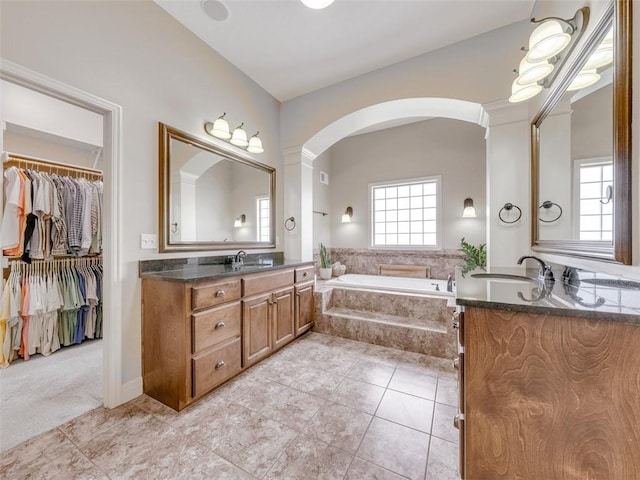 11599 S Carbondale St, Olathe, KS 66061 - bathroom with vanity, a garden tub, tile patterned flooring, and a spacious closet