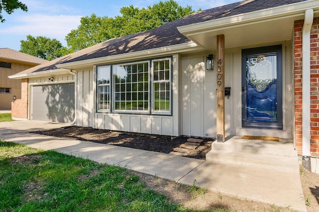 4309 S Huntington Way, Independence, MO 64055 - doorway to property with brick siding, an attached garage, roof with shingles, and board and batten siding