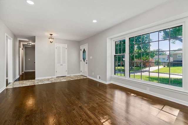 4309 S Huntington Way, Independence, MO 64055 - unfurnished living room featuring wood finished floors, plenty of natural light, and recessed lighting