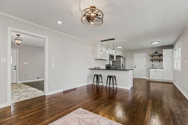 4309 S Huntington Way, Independence, MO 64055 - living area featuring dark wood-type flooring, crown molding, and recessed lighting
