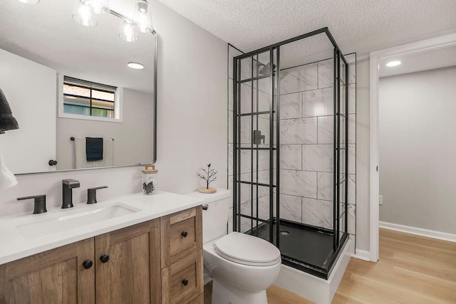 4309 S Huntington Way, Independence, MO 64055 - bathroom with a textured ceiling, vanity, a stall shower, and wood finished floors