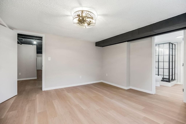 4309 S Huntington Way, Independence, MO 64055 - below grade area featuring a textured ceiling and light wood-style flooring