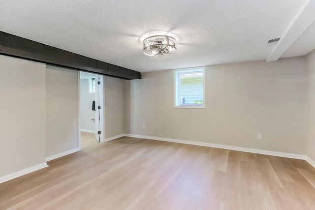4309 S Huntington Way, Independence, MO 64055 - basement with light wood-type flooring and a textured ceiling
