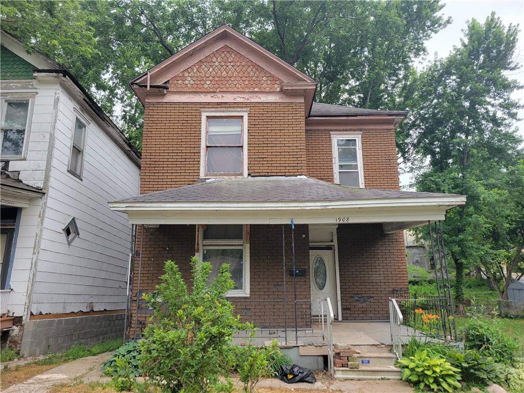 1908 Faraon St, Saint Joseph, MO 64501 - view of front of property with a porch, brick siding, and a shingled roof