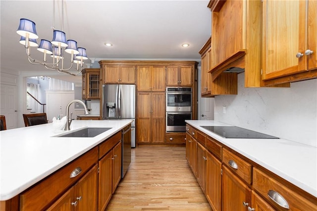 8620 N Eastern Ave, Kansas City, MO 64157 - kitchen with stainless steel appliances, brown cabinetry, light wood-style flooring, light countertops, and recessed lighting