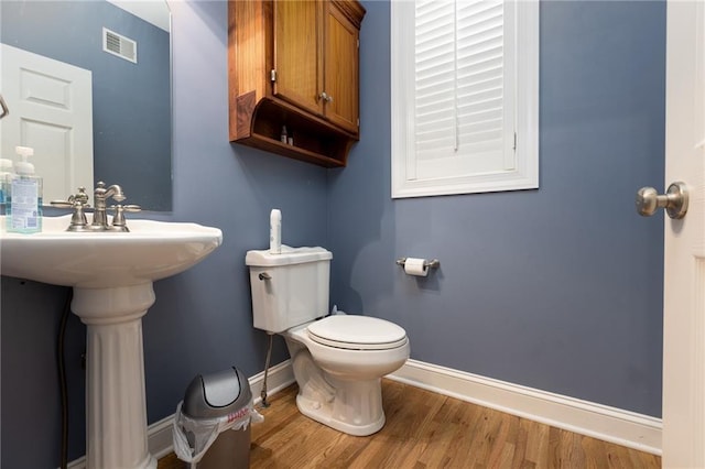 8620 N Eastern Ave, Kansas City, MO 64157 - half bathroom featuring toilet and wood finished floors