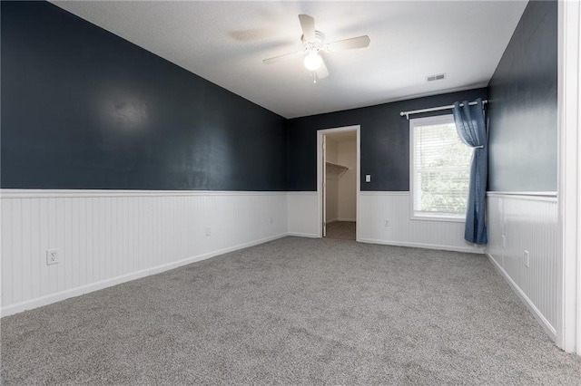 8620 N Eastern Ave, Kansas City, MO 64157 - spare room featuring ceiling fan, wainscoting, and carpet floors