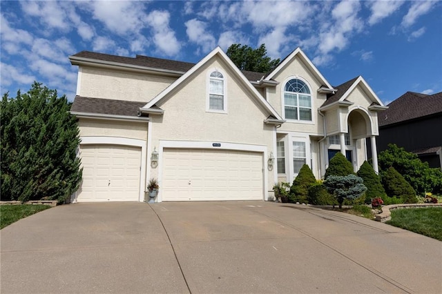 8620 N Eastern Ave, Kansas City, MO 64157 - traditional-style house with concrete driveway, a garage, and stucco siding