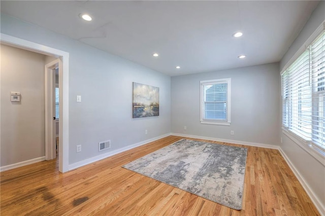 11417 Applewood Dr, Kansas City, MO 64134 - empty room featuring plenty of natural light, wood finished floors, and recessed lighting