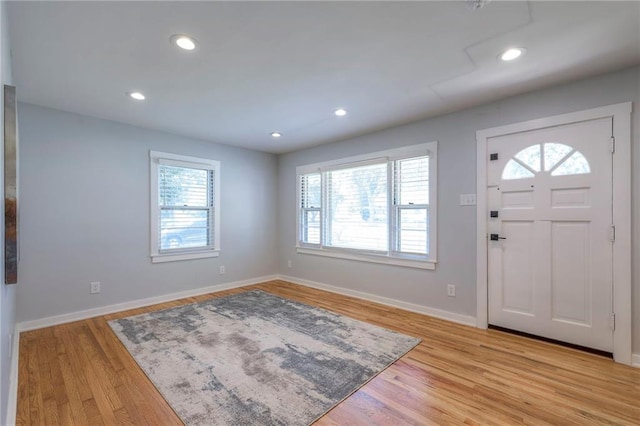 11417 Applewood Dr, Kansas City, MO 64134 - entryway with healthy amount of natural light, light wood-style floors, and recessed lighting