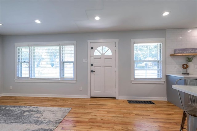 11417 Applewood Dr, Kansas City, MO 64134 - entrance foyer with healthy amount of natural light, light wood-style flooring, and recessed lighting