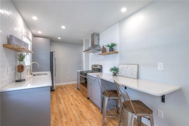 11417 Applewood Dr, Kansas City, MO 64134 - kitchen with open shelves, appliances with stainless steel finishes, wall chimney exhaust hood, gray cabinetry, and recessed lighting