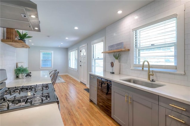 11417 Applewood Dr, Kansas City, MO 64134 - kitchen featuring gray cabinets, black dishwasher, range with gas stovetop, tasteful backsplash, and light wood finished floors