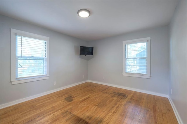 11417 Applewood Dr, Kansas City, MO 64134 - spare room featuring wood finished floors and baseboards