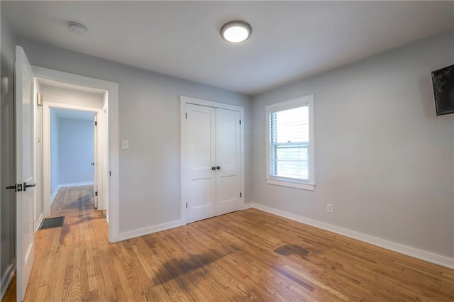 11417 Applewood Dr, Kansas City, MO 64134 - unfurnished bedroom featuring light wood-type flooring and a closet