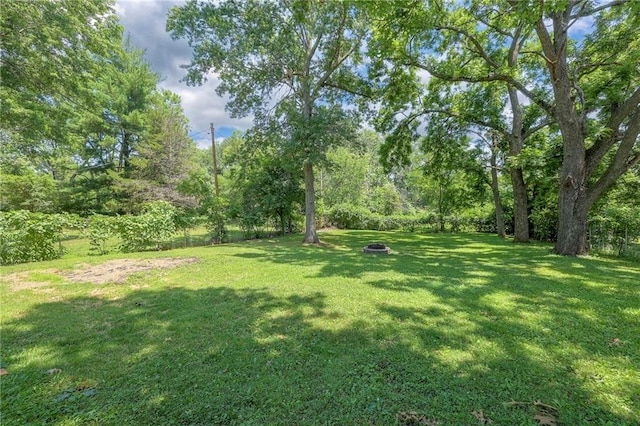 11417 Applewood Dr, Kansas City, MO 64134 - view of grassy yard with an outdoor fire pit