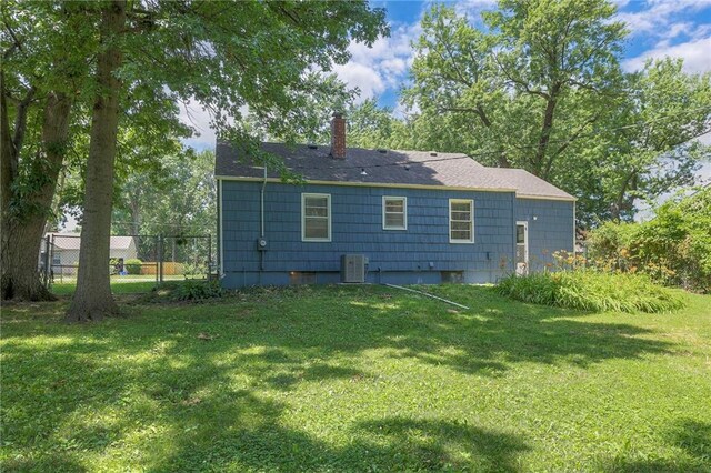 11417 Applewood Dr, Kansas City, MO 64134 - rear view of property with a chimney