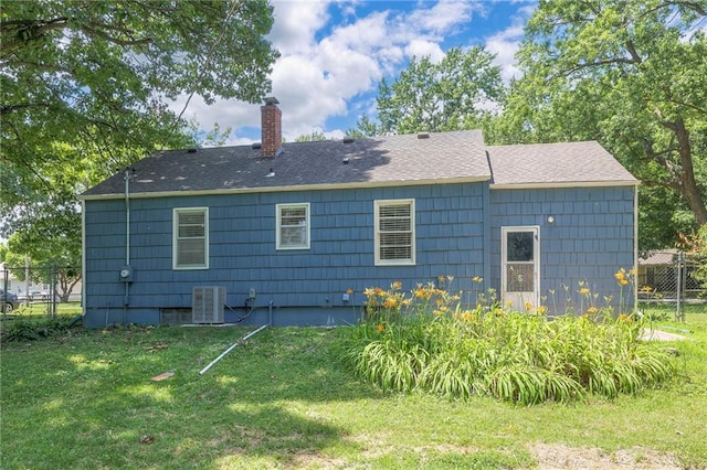 11417 Applewood Dr, Kansas City, MO 64134 - back of house with a chimney and roof with shingles