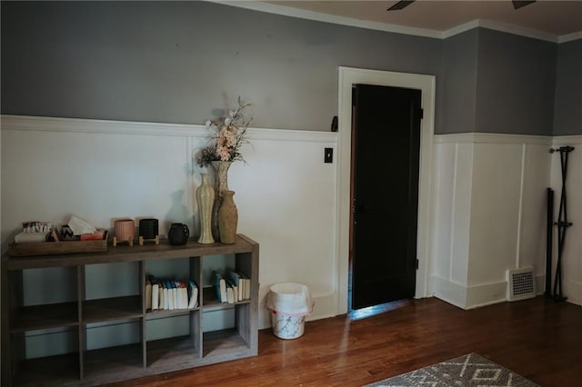 2220 Eugene Field Ave, Saint Joseph, MO 64505 - entryway with wood finished floors, crown molding, and a wainscoted wall
