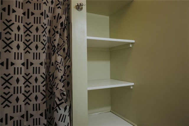 2220 Eugene Field Ave, Saint Joseph, MO 64505 - bathroom featuring a shower with shower curtain and baseboards