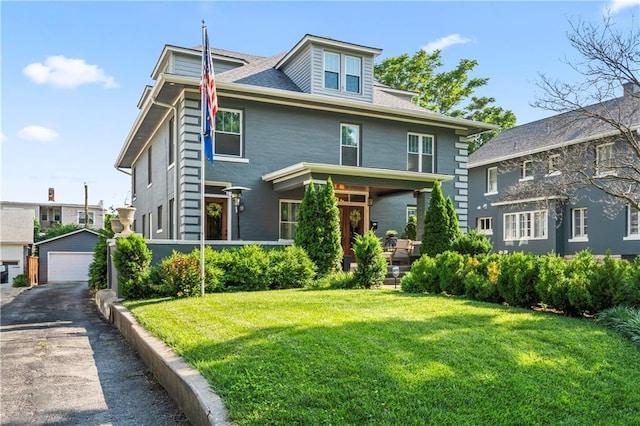 3215 Windsor Ave, Kansas City, MO 64123 - american foursquare style home featuring a garage, a front lawn, and an outdoor structure