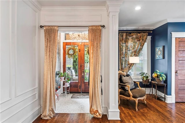 3215 Windsor Ave, Kansas City, MO 64123 - entrance foyer with ornamental molding, wood finished floors, and ornate columns