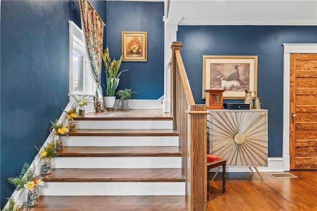 3215 Windsor Ave, Kansas City, MO 64123 - staircase with wood finished floors and ornamental molding
