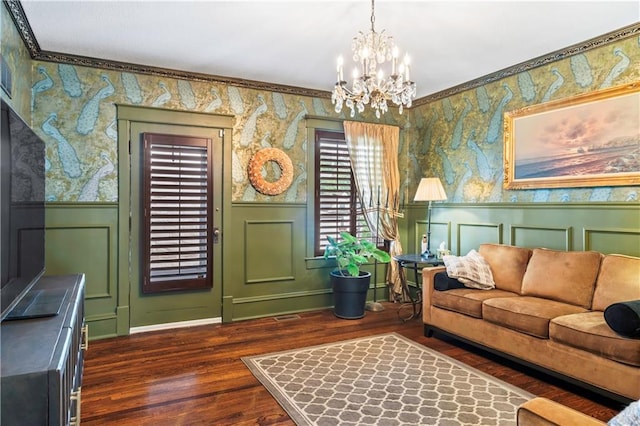 3215 Windsor Ave, Kansas City, MO 64123 - living area featuring wallpapered walls, a chandelier, wood finished floors, and wainscoting